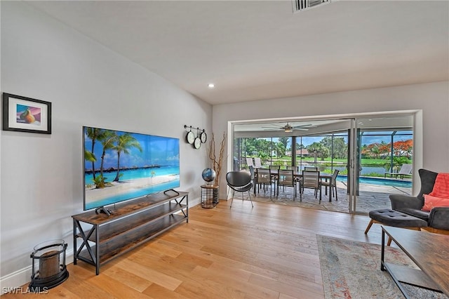 living room featuring light wood finished floors, visible vents, baseboards, ceiling fan, and recessed lighting