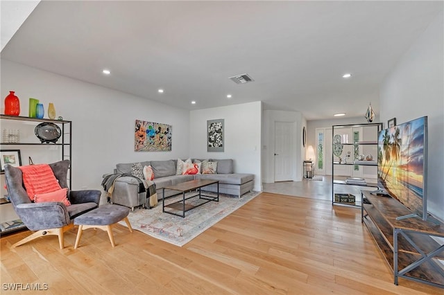 living area featuring light wood-style flooring, visible vents, and recessed lighting