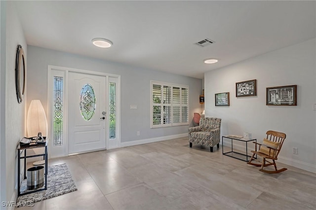 foyer with baseboards and visible vents