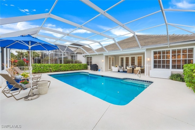 outdoor pool featuring glass enclosure, a patio, outdoor lounge area, french doors, and grilling area