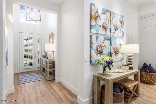 entrance foyer featuring light wood-type flooring and baseboards