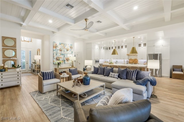 living room featuring visible vents, coffered ceiling, and light wood-style flooring