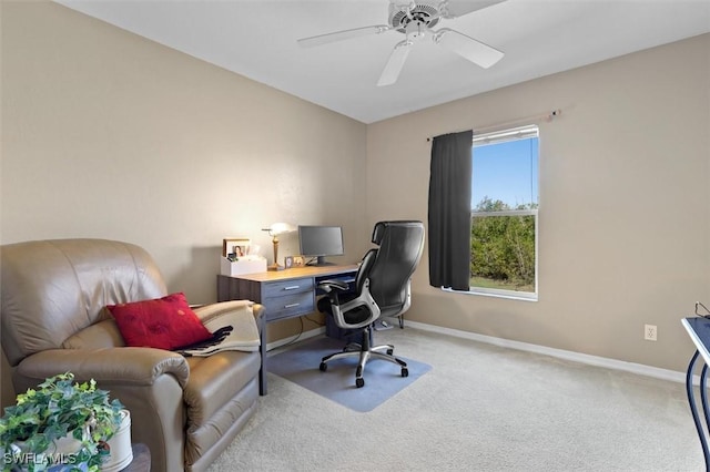 office featuring light carpet, ceiling fan, and baseboards