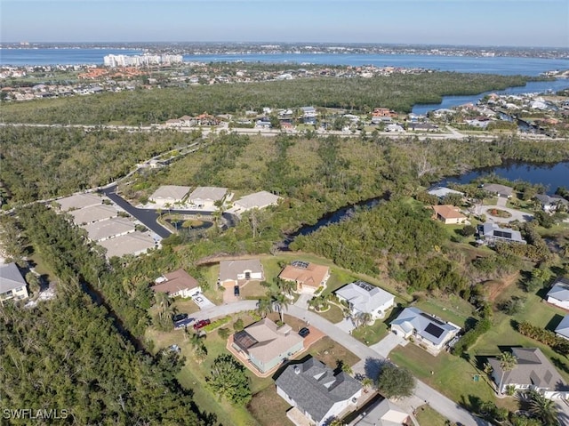 birds eye view of property with a water view and a residential view