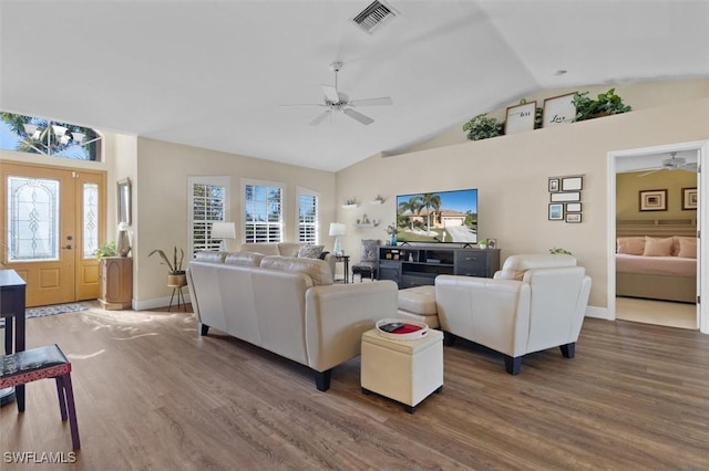 living area with baseboards, wood finished floors, visible vents, and a ceiling fan