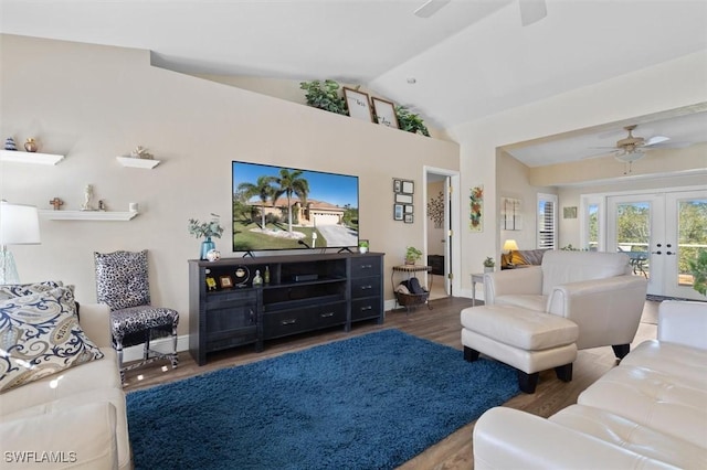 living area with lofted ceiling, wood finished floors, a ceiling fan, baseboards, and french doors