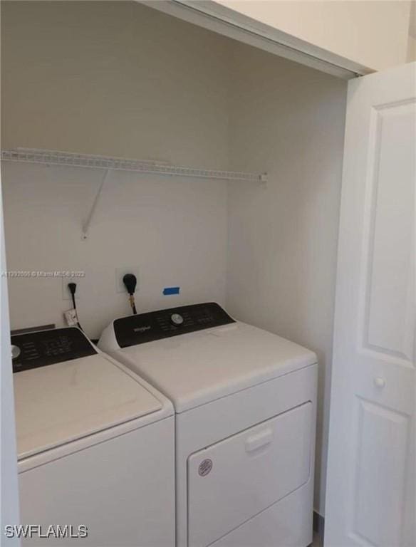 washroom featuring laundry area and separate washer and dryer