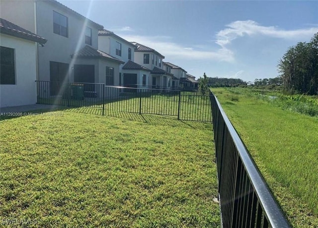 view of yard featuring a residential view and fence