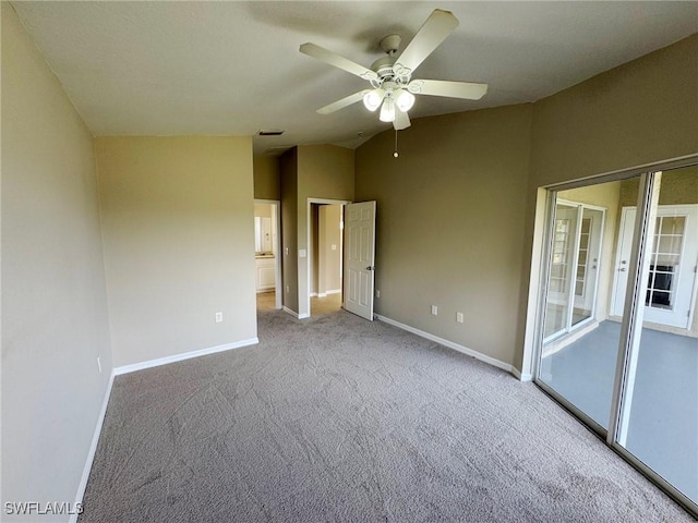 unfurnished bedroom featuring light colored carpet, visible vents, a ceiling fan, vaulted ceiling, and baseboards