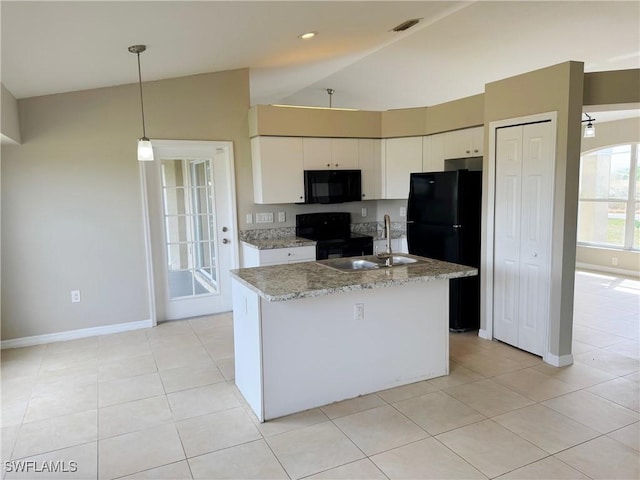 kitchen featuring lofted ceiling, light stone counters, white cabinetry, hanging light fixtures, and black appliances