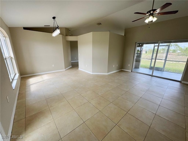 spare room with light tile patterned floors, visible vents, vaulted ceiling, ceiling fan, and baseboards