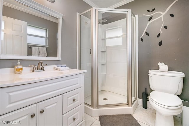 bathroom featuring toilet, a stall shower, vanity, and tile patterned floors