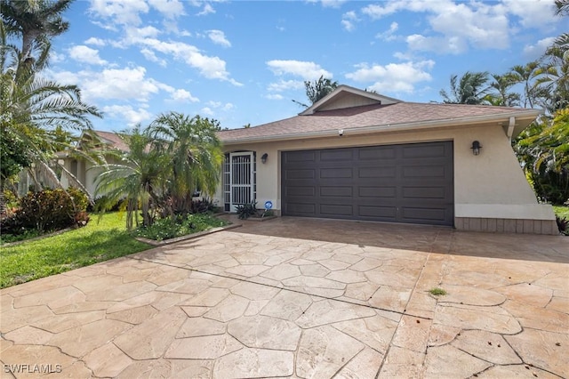 view of front of property with an attached garage, concrete driveway, and stucco siding