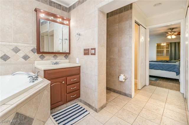 full bathroom with ensuite bath, a garden tub, crown molding, vanity, and tile walls