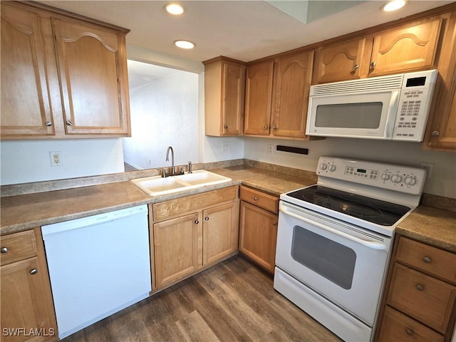 kitchen with white appliances, brown cabinets, dark wood-style flooring, a sink, and recessed lighting