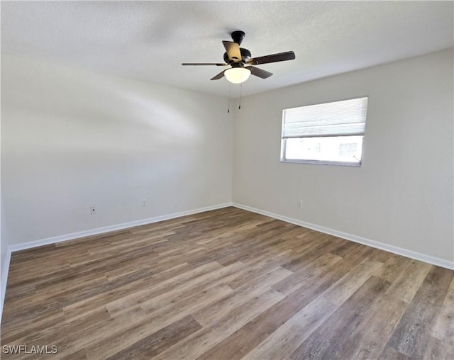 unfurnished room featuring a ceiling fan, a textured ceiling, baseboards, and wood finished floors