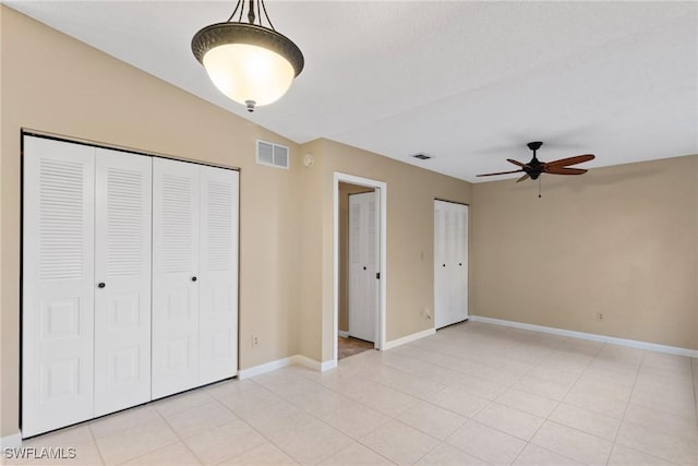 unfurnished bedroom with light tile patterned floors, visible vents, baseboards, and a closet