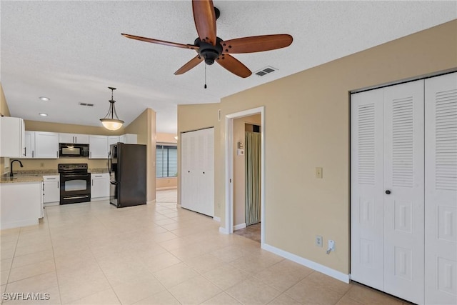 kitchen with a ceiling fan, visible vents, black appliances, white cabinets, and light countertops