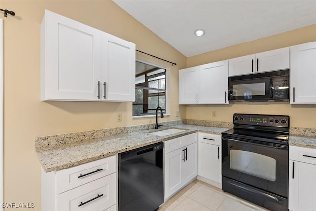 kitchen featuring light stone counters, light tile patterned flooring, a sink, black appliances, and white cabinetry