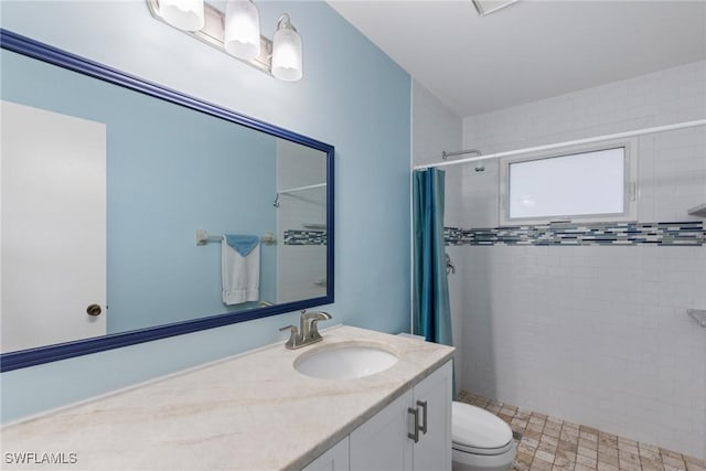 full bath with vanity, toilet, and a shower stall