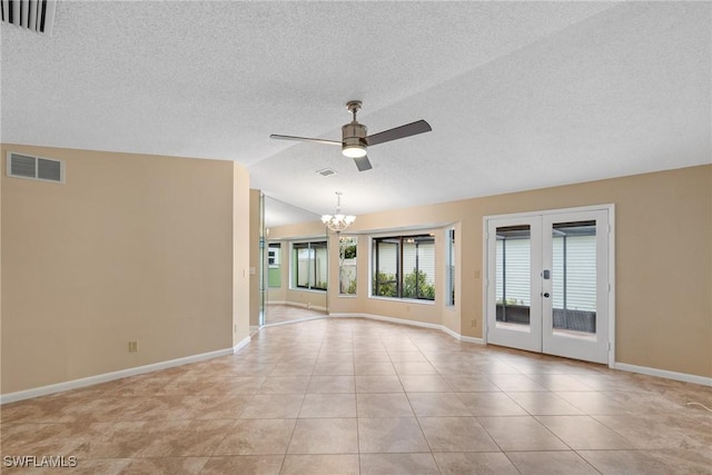 unfurnished room with visible vents, lofted ceiling, ceiling fan with notable chandelier, french doors, and light tile patterned flooring