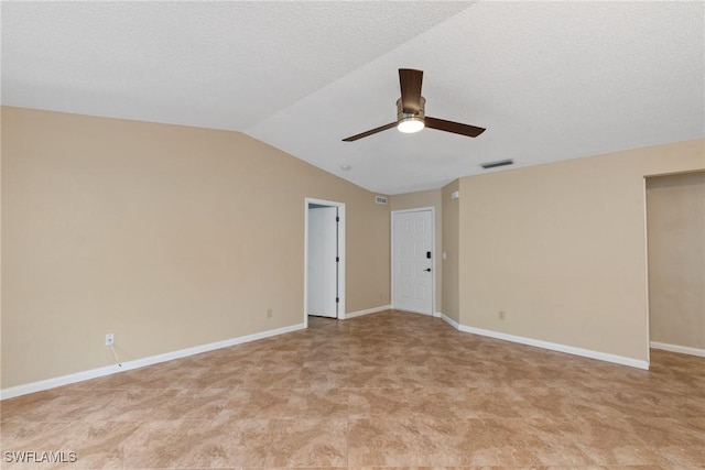 unfurnished room with baseboards, visible vents, ceiling fan, vaulted ceiling, and a textured ceiling