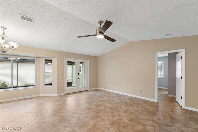 spare room featuring visible vents, baseboards, light tile patterned flooring, vaulted ceiling, and ceiling fan with notable chandelier