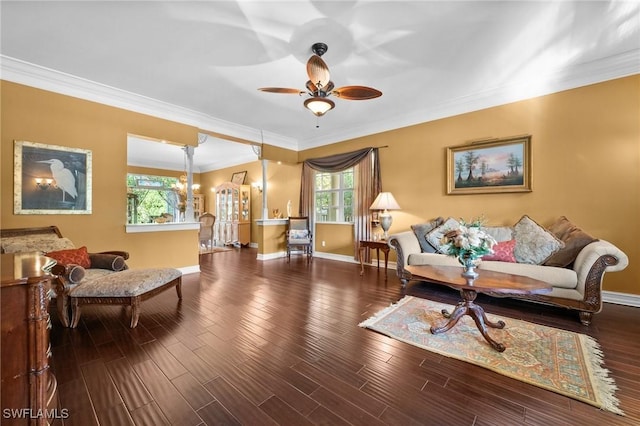 living room featuring ornamental molding, dark wood finished floors, baseboards, and a ceiling fan