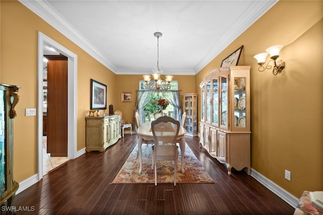 dining space with dark wood-type flooring, ornamental molding, baseboards, and an inviting chandelier