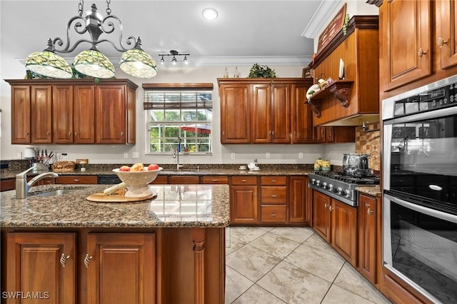 kitchen featuring dark stone counters, appliances with stainless steel finishes, a kitchen island, and a sink