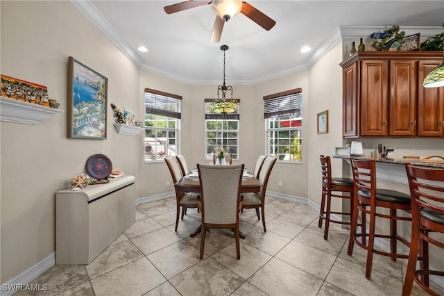 dining space with baseboards, plenty of natural light, and crown molding