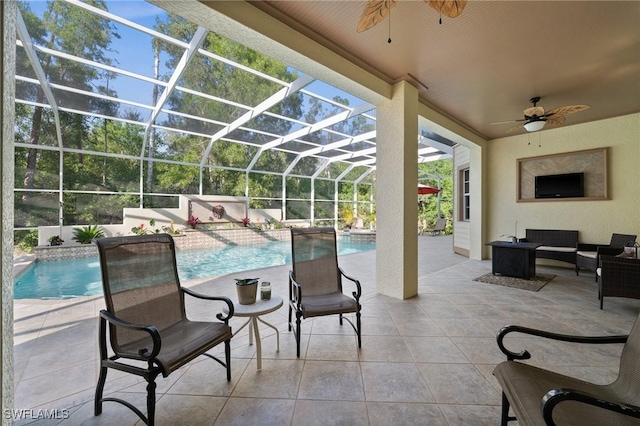 view of patio / terrace with a ceiling fan, a lanai, an outdoor pool, and an outdoor hangout area