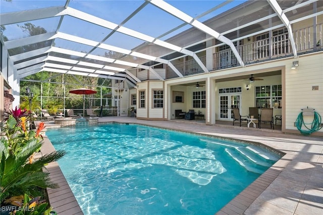 pool with ceiling fan, a patio area, and a lanai