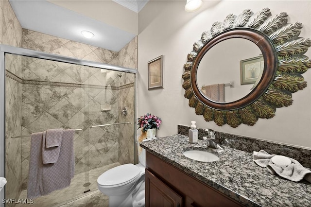 full bathroom featuring a stall shower, vanity, and toilet