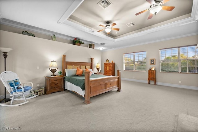 bedroom featuring a tray ceiling, visible vents, ornamental molding, light carpet, and baseboards