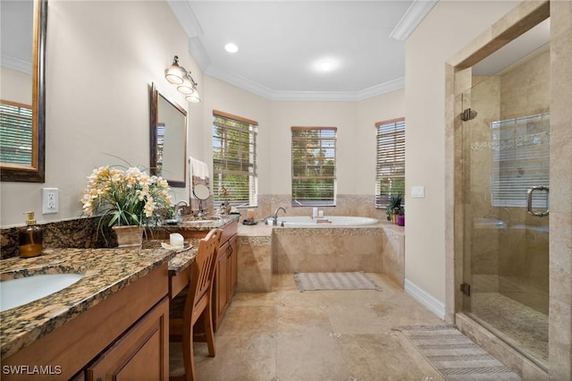 full bathroom featuring a stall shower, a garden tub, crown molding, and vanity