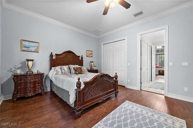 bedroom with dark wood-style flooring, visible vents, baseboards, ornamental molding, and a closet