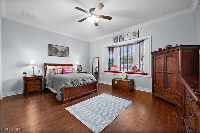 bedroom with ornamental molding, dark wood-type flooring, visible vents, and baseboards