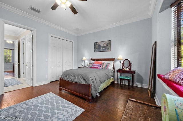 bedroom with baseboards, visible vents, ornamental molding, and dark wood-type flooring