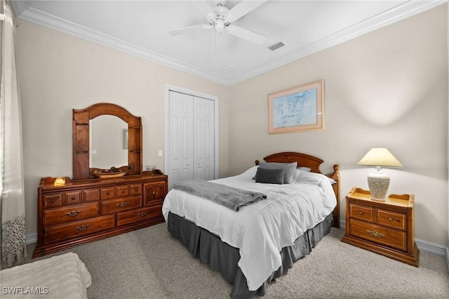 bedroom featuring a closet, light colored carpet, visible vents, and crown molding