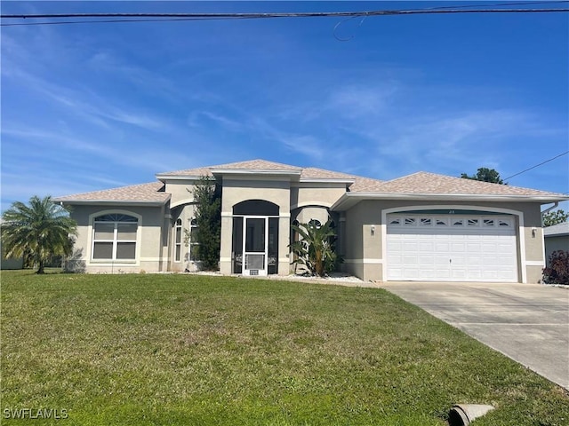 view of front of house with a garage, a front lawn, concrete driveway, and stucco siding