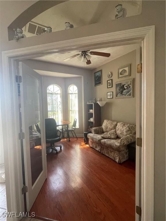 interior space featuring ceiling fan, french doors, wood finished floors, and baseboards