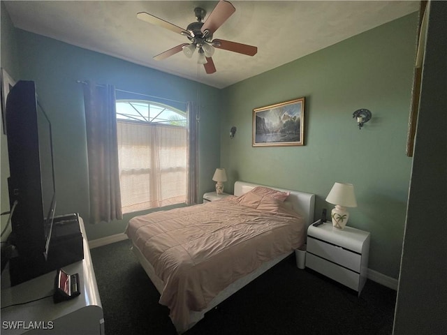 carpeted bedroom with ceiling fan and baseboards