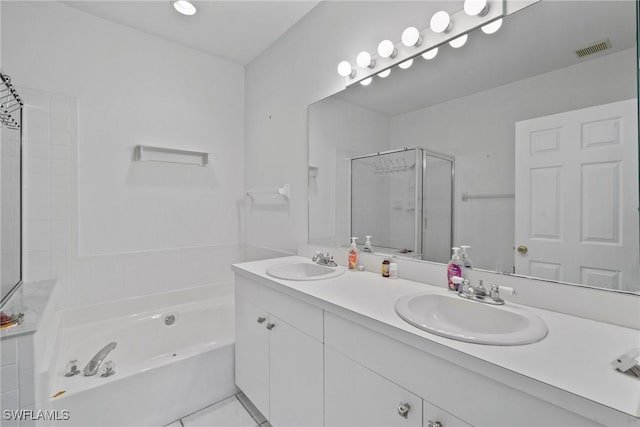 bathroom with visible vents, a sink, a shower stall, and double vanity