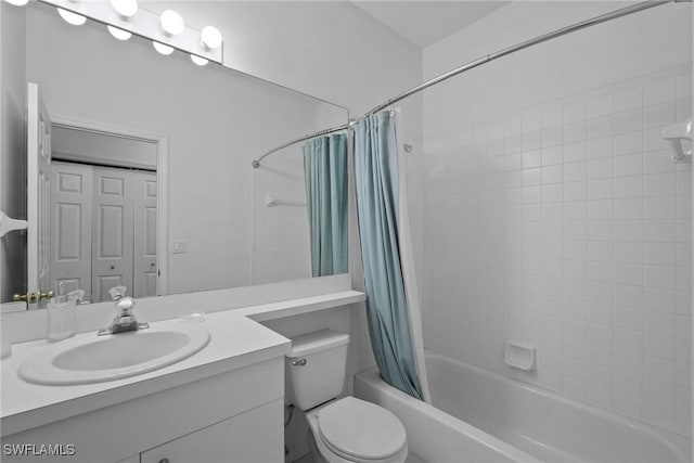 bathroom with a closet, vanity, toilet, and shower / bath combo with shower curtain