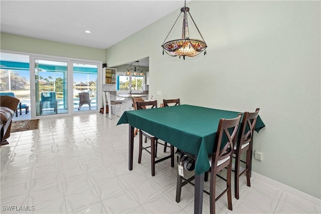 dining area with light floors, baseboards, and recessed lighting