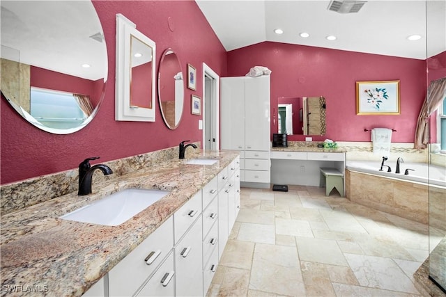 full bathroom with lofted ceiling, visible vents, a sink, and double vanity