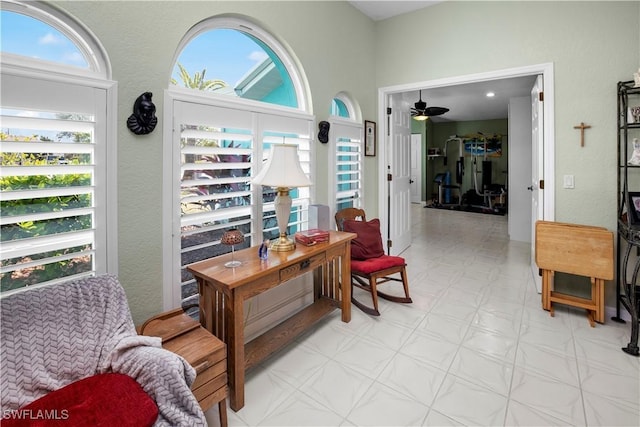 living area with ceiling fan and light floors