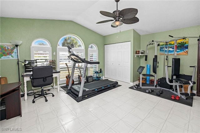 exercise area featuring baseboards, vaulted ceiling, and a ceiling fan