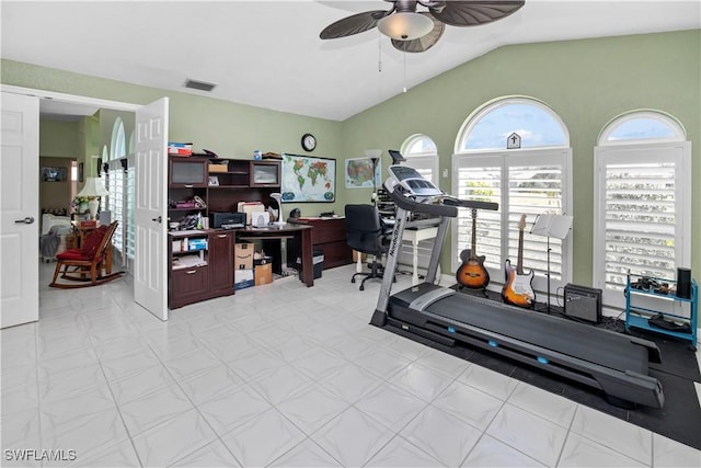 exercise room with visible vents, vaulted ceiling, and ceiling fan